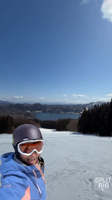 Face Mode cutout, snowboarder laughing on a frozen-lake piste.